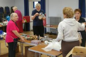 A group of people getting ready for a jumble sale